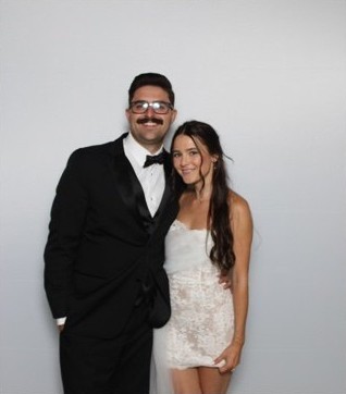 Couple posing together in the La Vida photo booth in formal wear