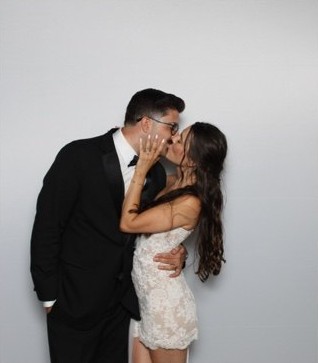 Newlyweds posing for a portrait in the La Vida photo booth