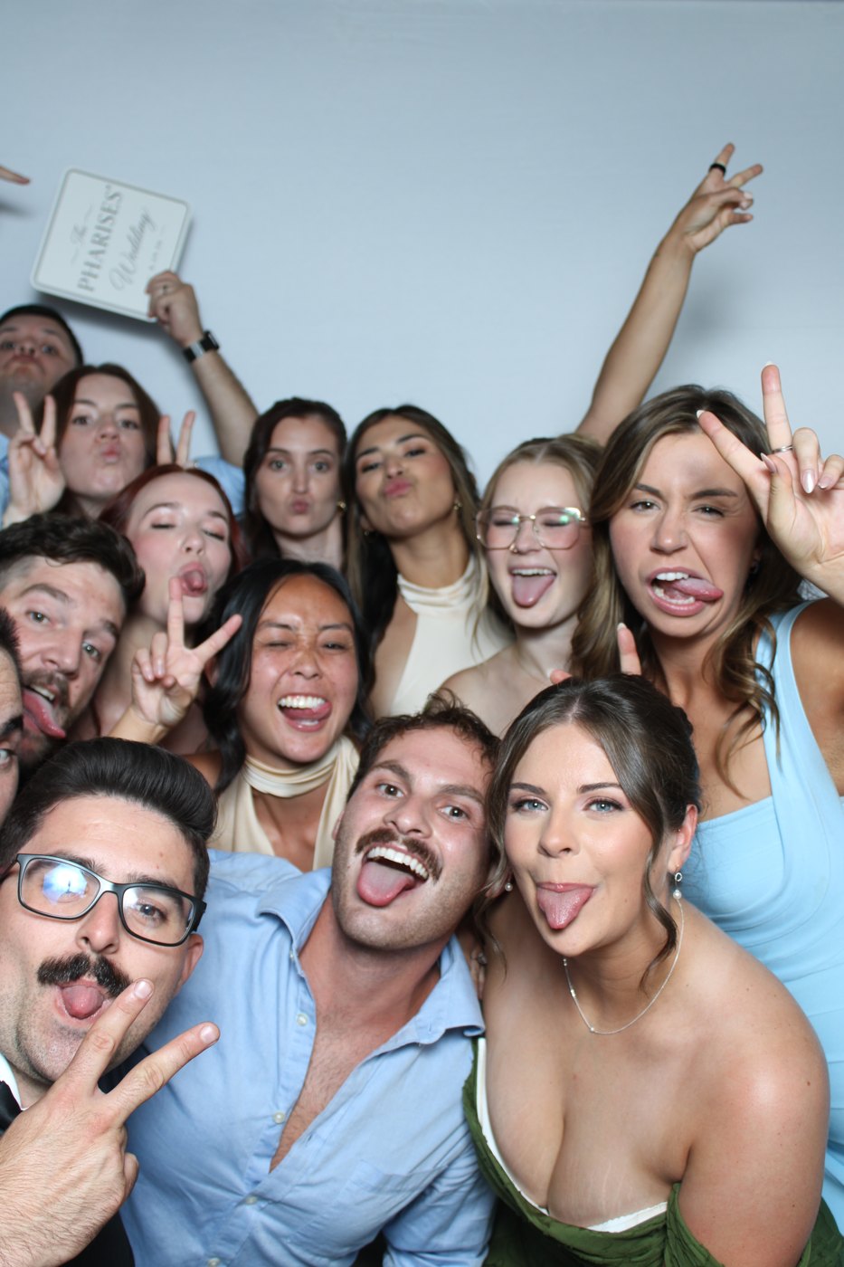 A large group of friends squeezed together for a photo booth picture